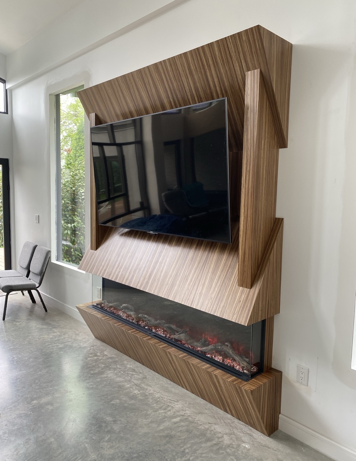 Custom walnut media wall and fireplace surround