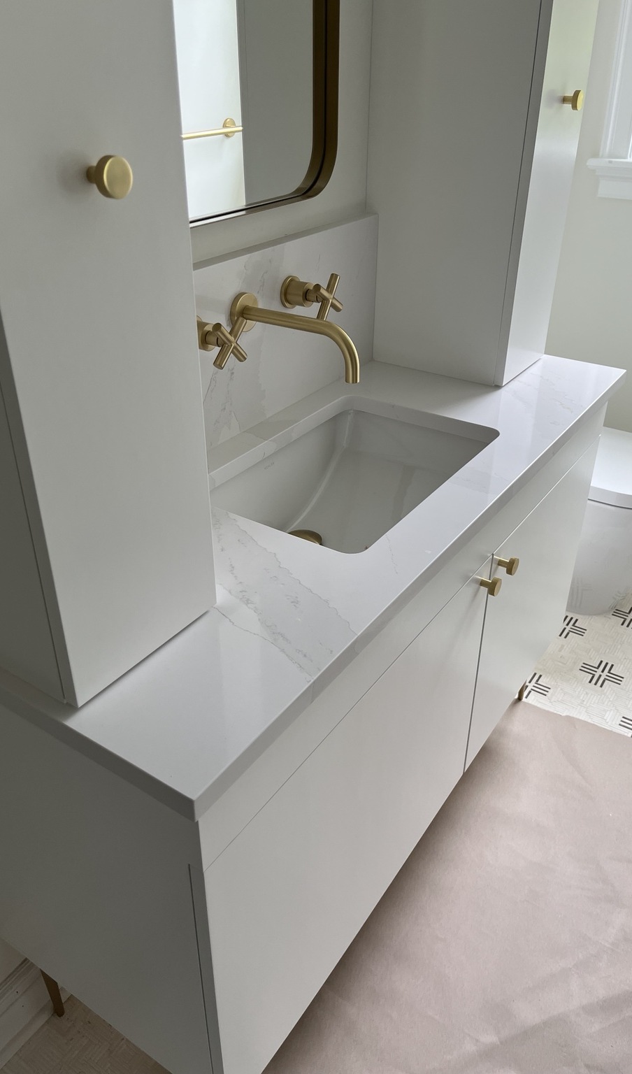 White custom bathroom vanity with integrated stone sink