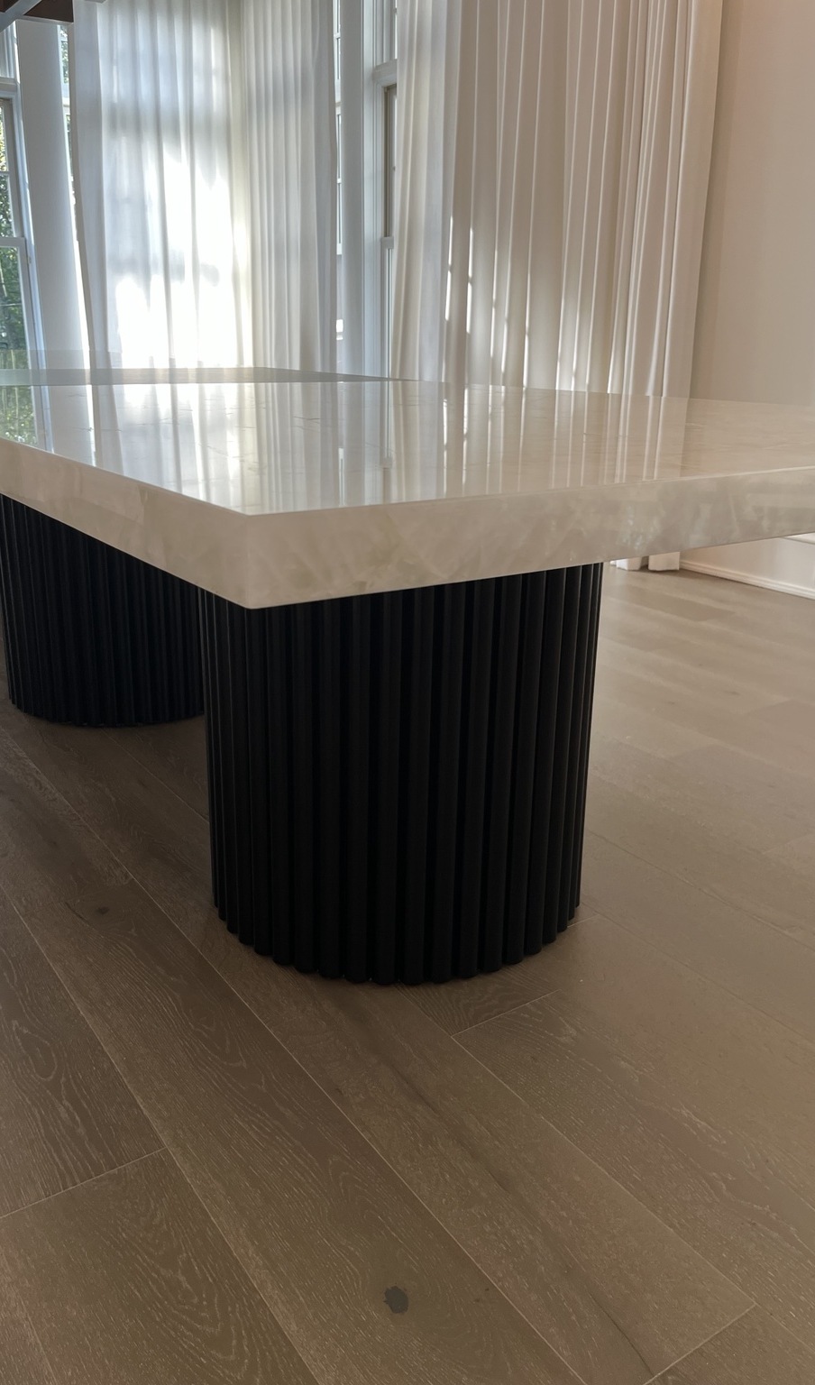 Custom dining table with fluted black bases