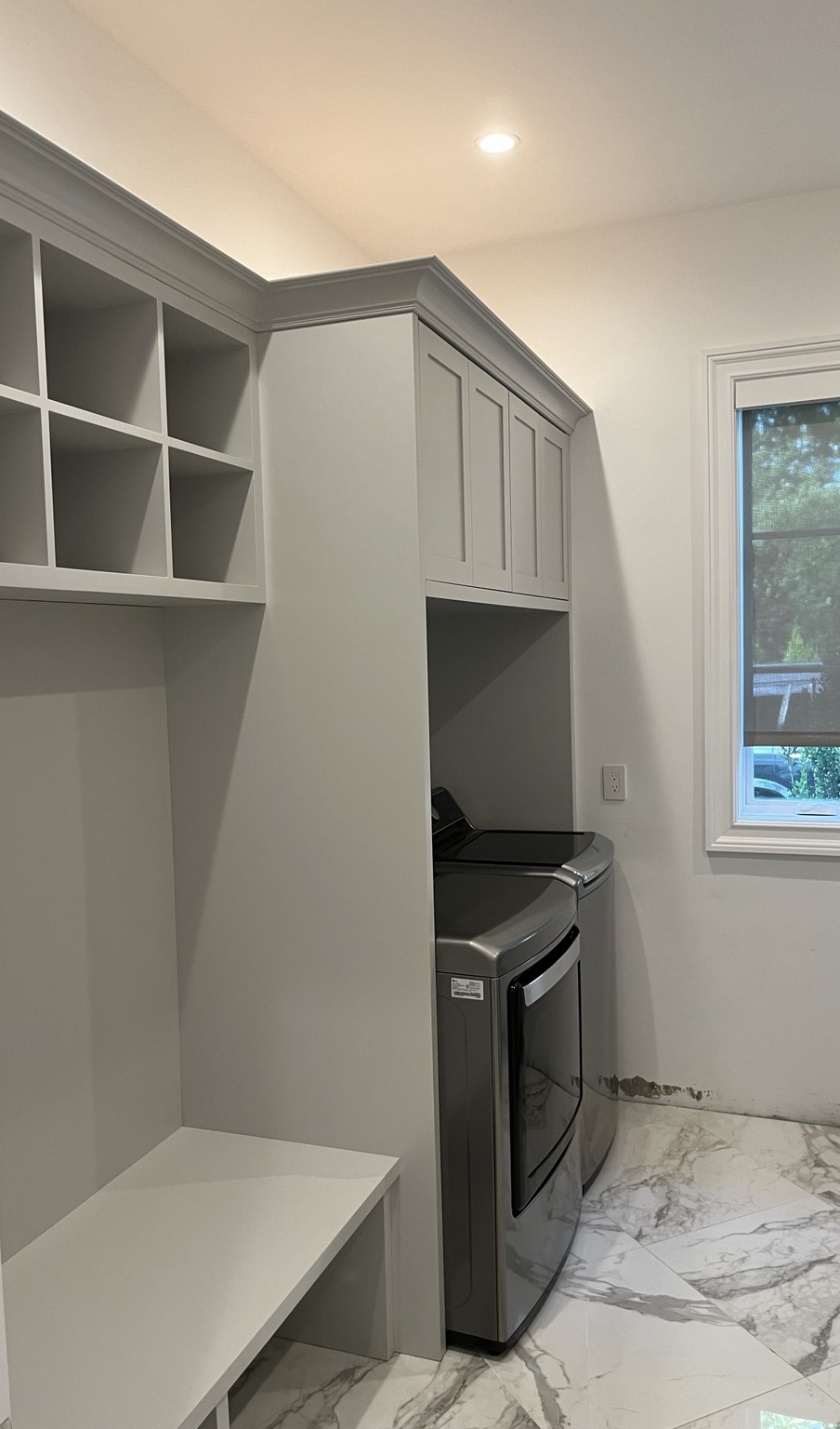 Gray built-in laundry room cabinetry